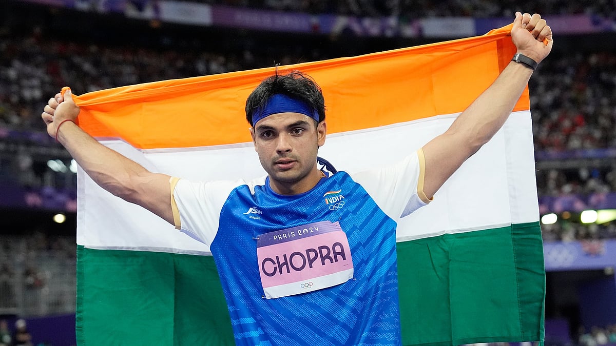 (AP Photo/Matthias Schrader) : Silver medalist, Neeraj Chopra, of India, celebrates after the men's javelin throw final at the 2024 Summer Olympics, Thursday, Aug. 8, 2024, in Saint-Denis, France. 
